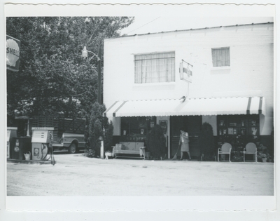 Series SF-95-SF6: Clay Co., woman sweeping at Shell gas station