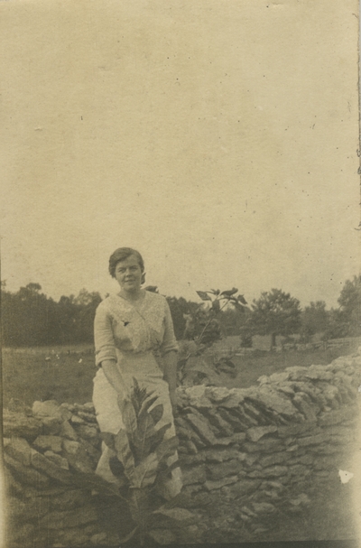 woman by stone wall