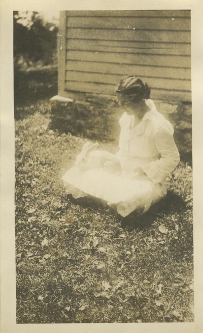 woman holding a rabbit; same photo as #52