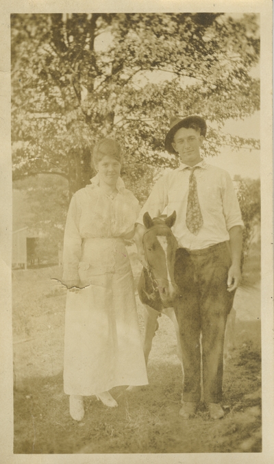 young woman and man with horse