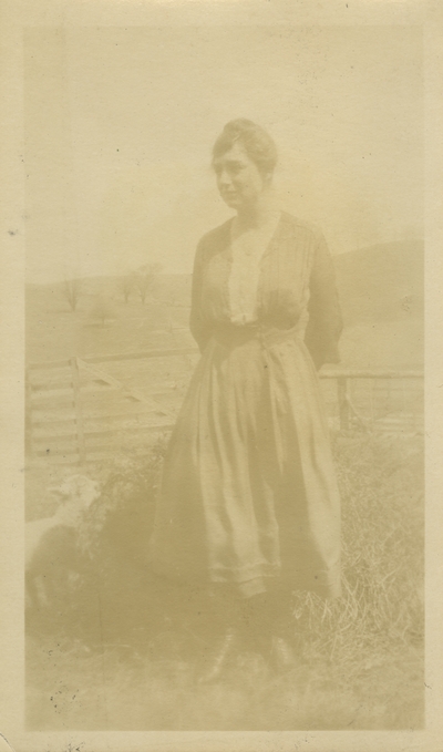 unidentified woman standing by field