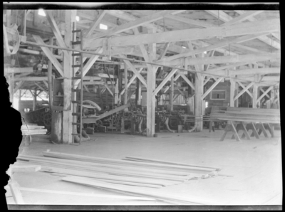 Interior of lumber mill, showing saw tables