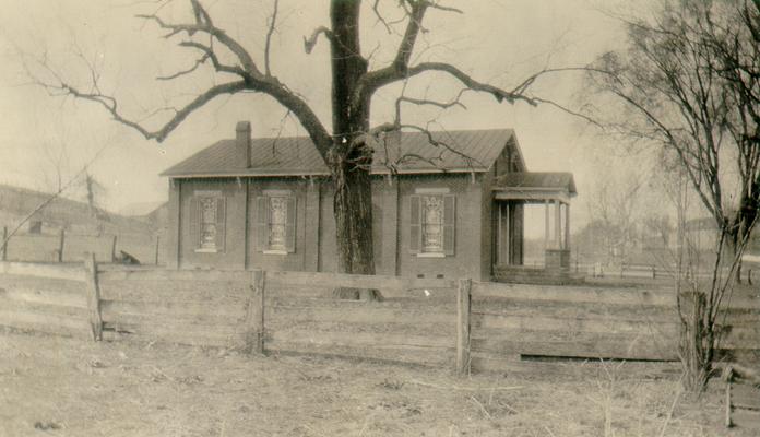 Grassy Lick Methodist Episcopal Church, a brick building now about 75 [seventy-five] years old. The big tree is a black walnut, probably well over a hundred years old, about 150 [one hundred fifty] yards due West of this building and on top of the hill is the old burying ground and church lot where the original 'Methodist Meeting-house' stood. The burying ground occupies about an acre and is still reserved