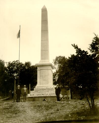 Blue Licks to Judge Wilson from W.M. Ingram. August 19, 1928. Blue Licks Battle Ground, KY. State Park No. 5; Sam Wilson and two other man in front of monument, flag in background