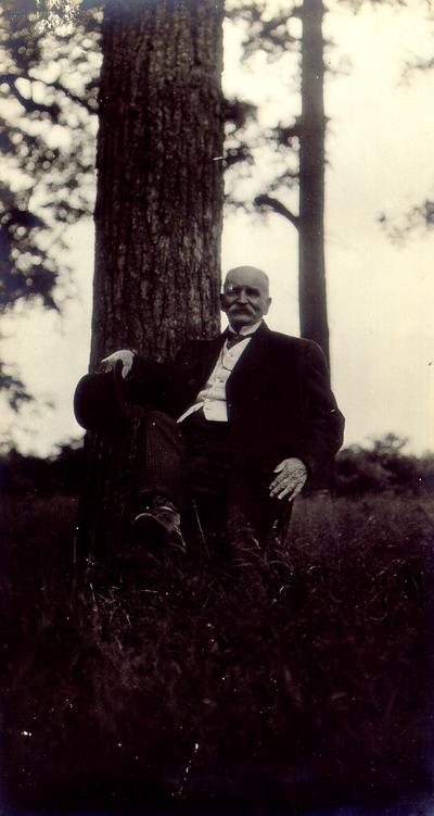 Payne's Depot. Man sitting next to tree