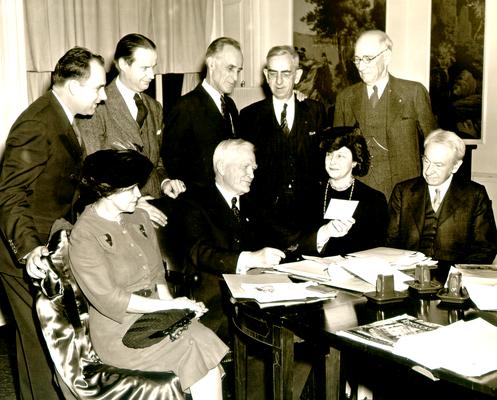 Front: Mrs. W.B. Ardery, Judge Samuel M. Wilson, Mrs. Drake, and Mr. Thurston; Back row: Harry B. MacKoy, John Noland and H.V. McChesney.; Pendemin's [sp?] Club in Louisville, KY