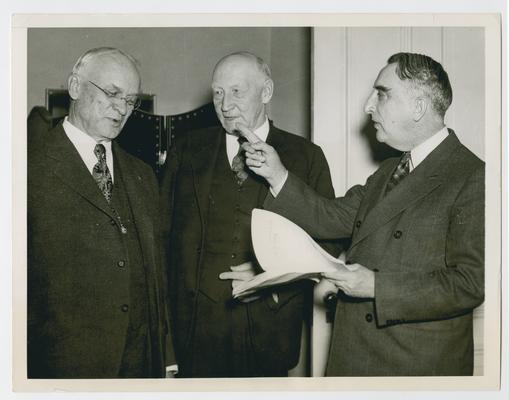 Vinson, right, discusses document with two others