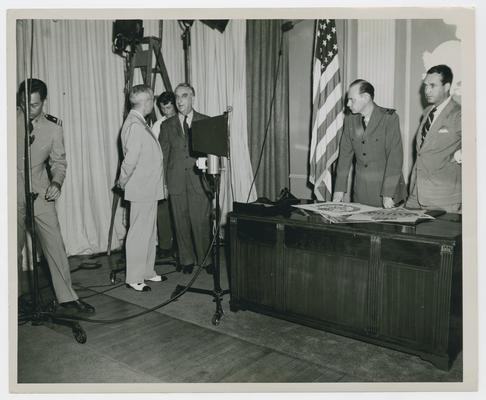 Secretary Vinson speaks with officials and military officers as they prepare promotion. Official US Coast Guard photo