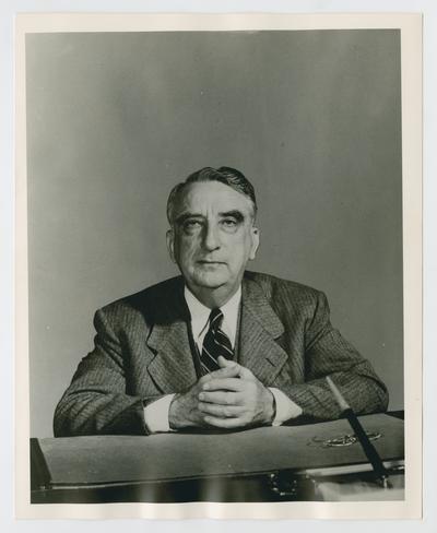 Secretary Vinson seated at his desk