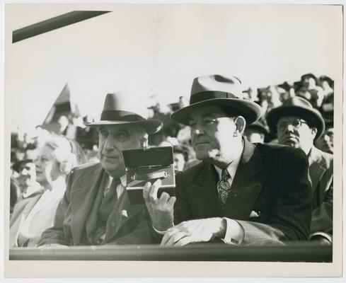 Chief Justice Vinson and Postmaster General Hannegan watch a St. Louis Cardinals baseball game. Inscribed