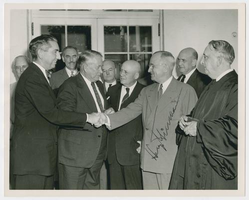 Swearing-in ceremony of Tom C. Clark as associate justice of the Supreme Court. Front row left to right: Justice Clark; Vice President Barkley; Speaker Rayburn; President Truman; and Chief Justice Vinson. Back row left to right: Secretary Sawyer; Secretary Acheson; Secretary Snyder; and Secretary Johnson. Signature of President Truman