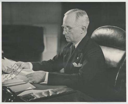 Harry Truman at his desk. Inscribed