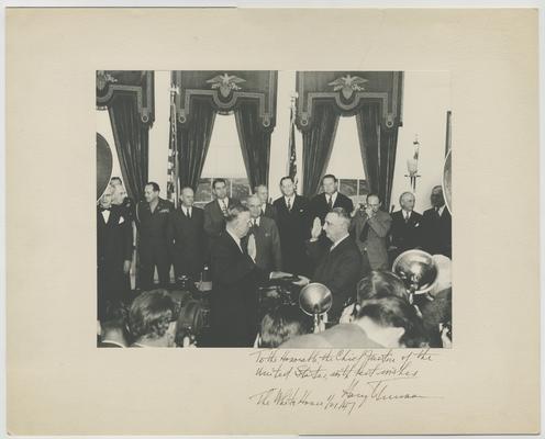 Chief Justice Vinson swears in George C. Marshall as Secretary of State. Inscription by President Truman: To the Honorable Chief Justice of the United States, with best wishes, The White House