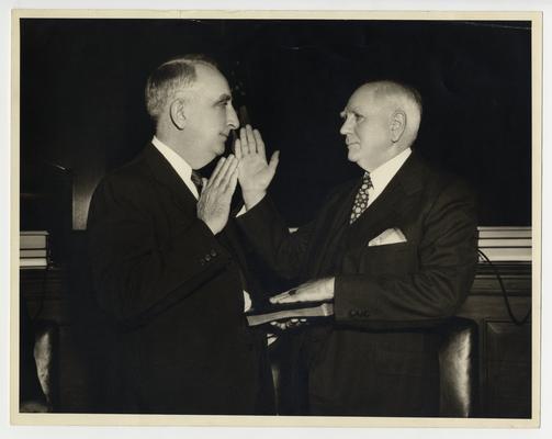 Secretary of the Treasury Vinson swears in unidentified man