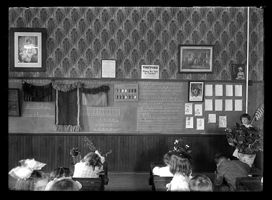 Elementary school picture, visitors sign on wall