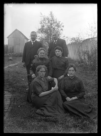 Dicker family, two men, four women seated in row