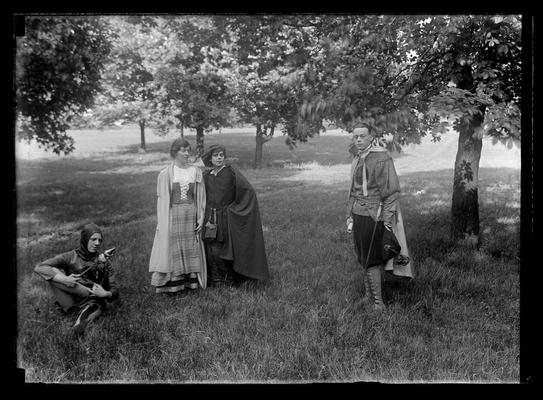 Pageant, play, four actors under trees, court jester to left