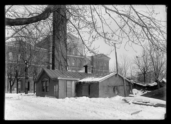 Heating plant, close-up framed by branches of tree