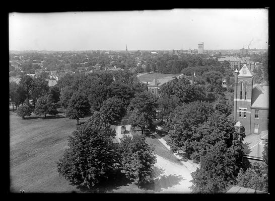 View from Old Main, tower of Barker Hall to right, students in vehicle in driveway (wagon)