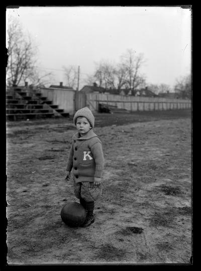 Mascot, small boy standing beside basketball, J.J. Tigert, Jr