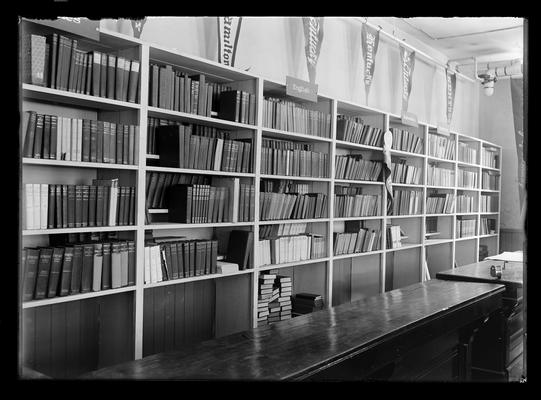 Books by classification on shelves, many of the same volumes