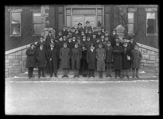 Democratic Club on steps of Miller Hall wearing coats and hats, woman near center front