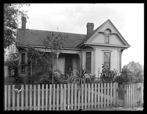 Murray House, man and dog on porch, picket fence