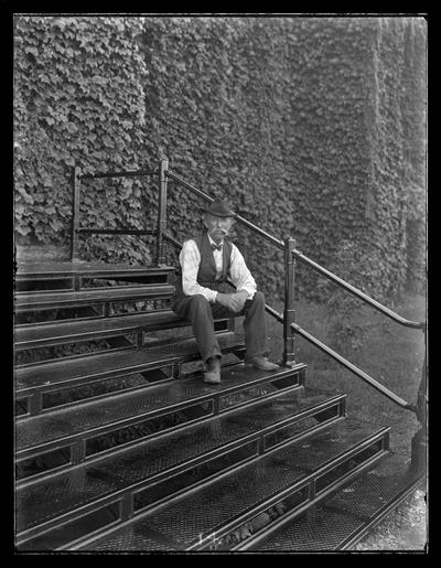 James Murray on steps of Administration Building (Main Building)