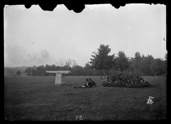 Cannon, flower bed, two students, and a dog