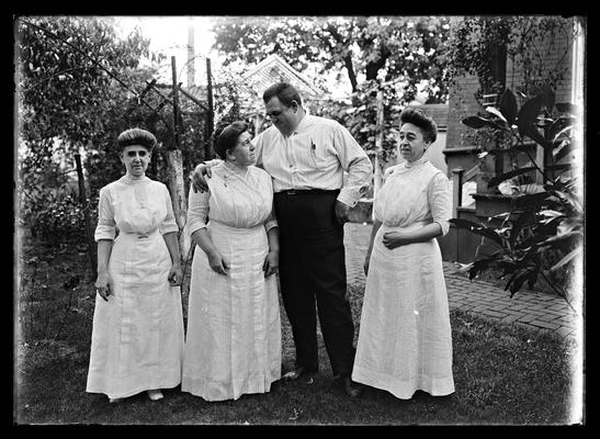 Three women, man, in backyard