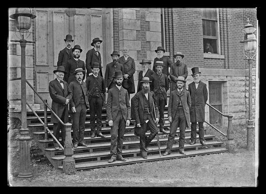 University of Kentucky faculty group, 1885, standing, hats on, on steps of Administration Building (Main Building)