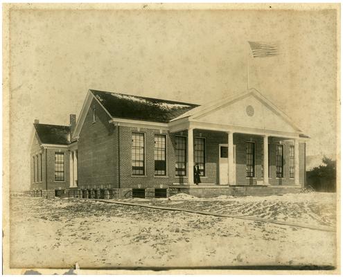 Nannie Faulconer (1865?-1940) standing on front porch of Faulconer school house