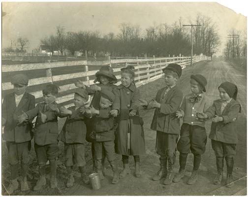 Group portrait of Greendale students posed with their hands outstretched. Handwriting on verso. (Three copies)