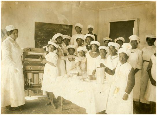 Group portrait of Cadontown students in cooking class with teacher, Callie Green and supervisor