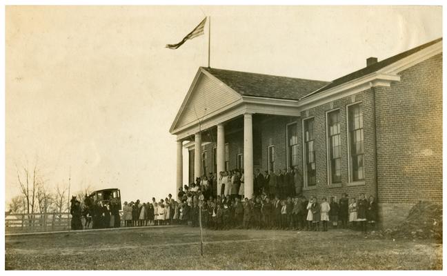 Group portrait of Picadome students standing in front of the school house. Handwritten on verso, Modern Type. Picadome. (Four copies)