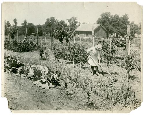 Portrait of an unknown girl tilling up a garden