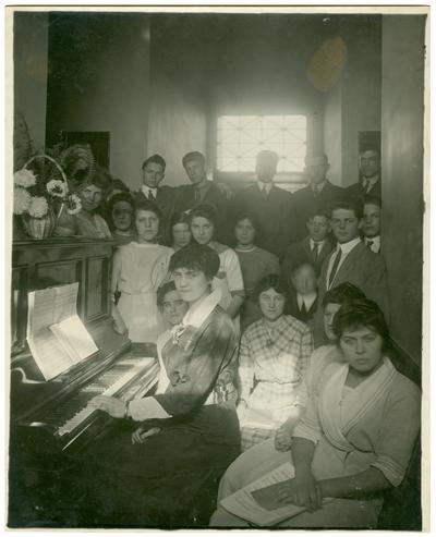 Group portrait of Camillus [Camillus Spain] Sullivan at the piano with other students and Nannie Faulconer (1865?-1940)