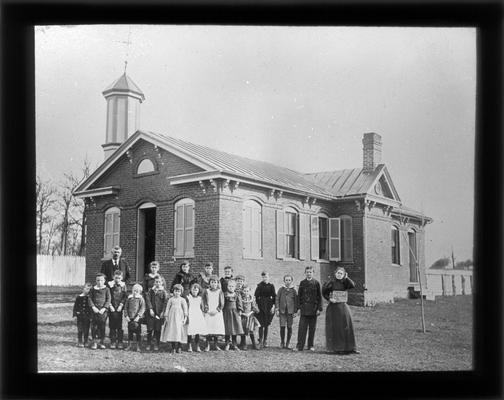 Students outside Little Picadome School with Miss Sara Drake, teacher, and County Superintendent M.A. Cassidy who coined the name