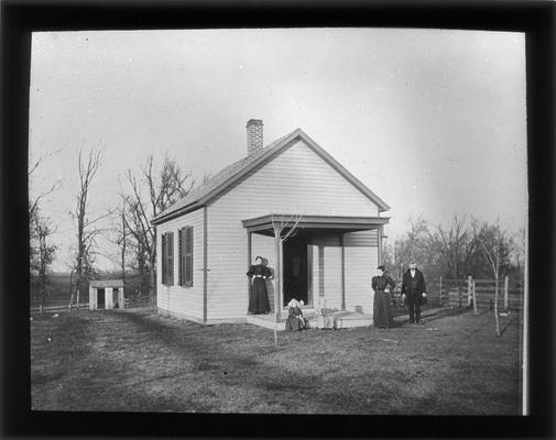 Exterior of Warfield School, Winchester Pike, with Miss Lula Clugston, teacher, M.A. Cassidy, county superintendent, one unidentified woman and two unidentified girls