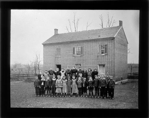 Students outside Loradale School with Miss Vest, teacher