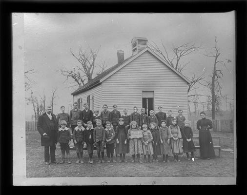 Students outside Russell Cave School with Miss Alice Moore, teacher