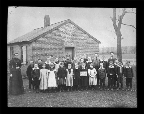 Students outside Muir School with Miss Sledd, teacher