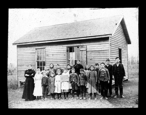 Students outside Whitsitt School with Miss Cora Vest, teacher