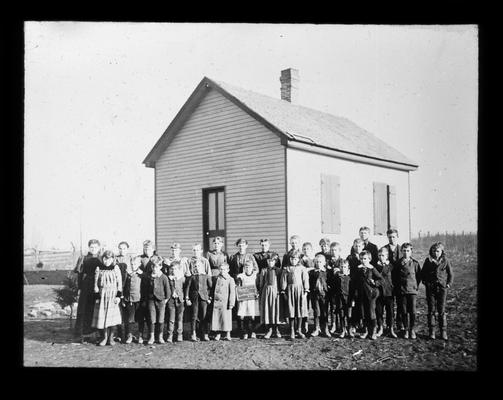 Students outside Brighton School with Miss Maude Christian, teacher