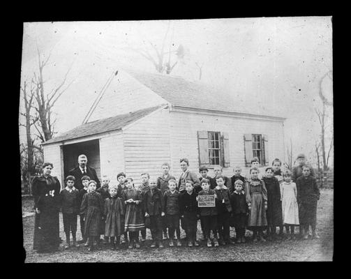 Students outside Tyler School, on Spurr Road, with Miss Charlotte Pilcher, teacher