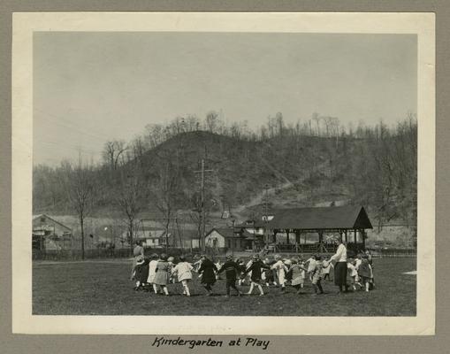 Title handwritten on photograph mounting: Kindergarten at Play