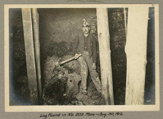 Title handwritten on photograph mounting: Log Found in No. 202 Mine