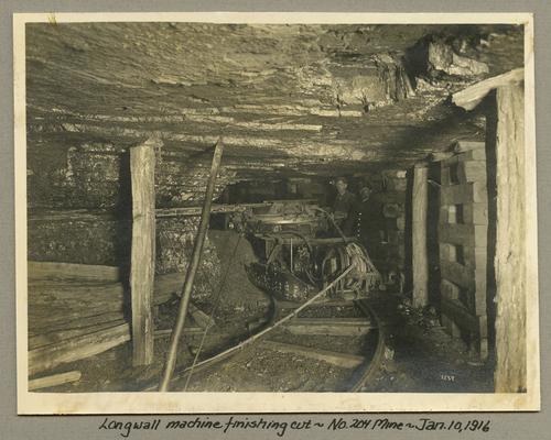 Title handwritten on photograph mounting: Longwall machine finishing cut at No. 204 Mine
