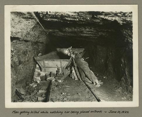 Title handwritten on photograph mounting: Man getting killed while watching car being placed on track