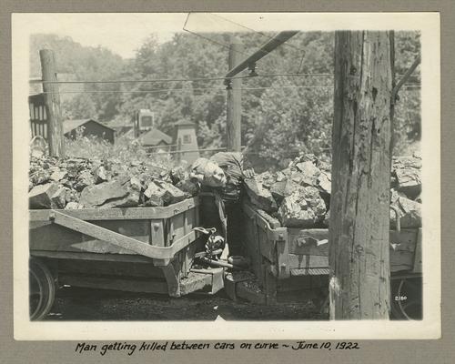 Title handwritten on photograph mounting: Man getting killed between cars on curve